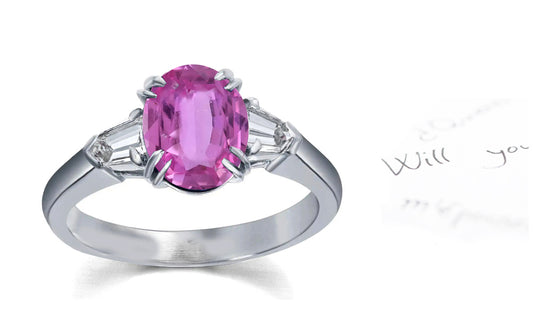 106 custom made unique oval cut pink sapphire center stone and bullet diamond side three stone engagement ring