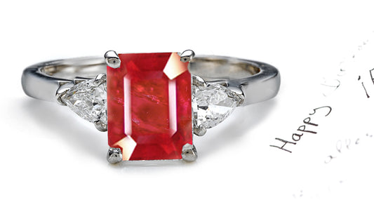 engagement ring three stone with emerald cut ruby center and side pear diamonds