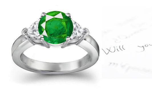 engagement ring three stone with round emerald center and side trillion diamonds