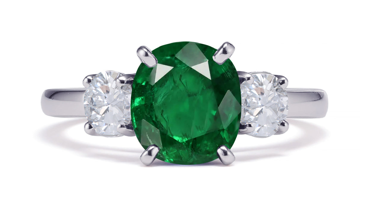 231 custom made unique oval emerald center stone and round diamond side three stone engagement ring