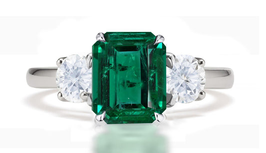 290 custom made unique emerald cut emerald center stone and round diamond accent three stone engagement ring