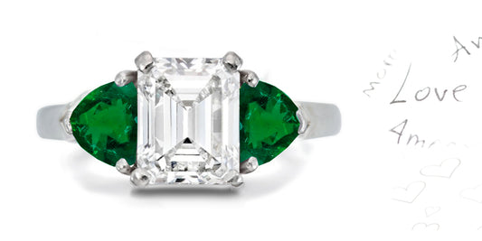303 custom made unique emerald cut diamond center stone and heart emerald accent three stone engagement ring