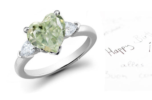 engagement ring three stone with green heart diamond center and side white pear diamonds