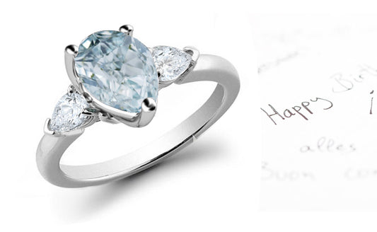 engagement ring three stone with pear blue diamond center and side pear white diamonds
