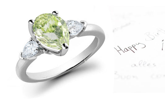 engagement ring three stone with pear green diamond center and side pear white diamonds