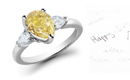 engagement ring three stone with pear yellow diamond center and side pear white diamonds