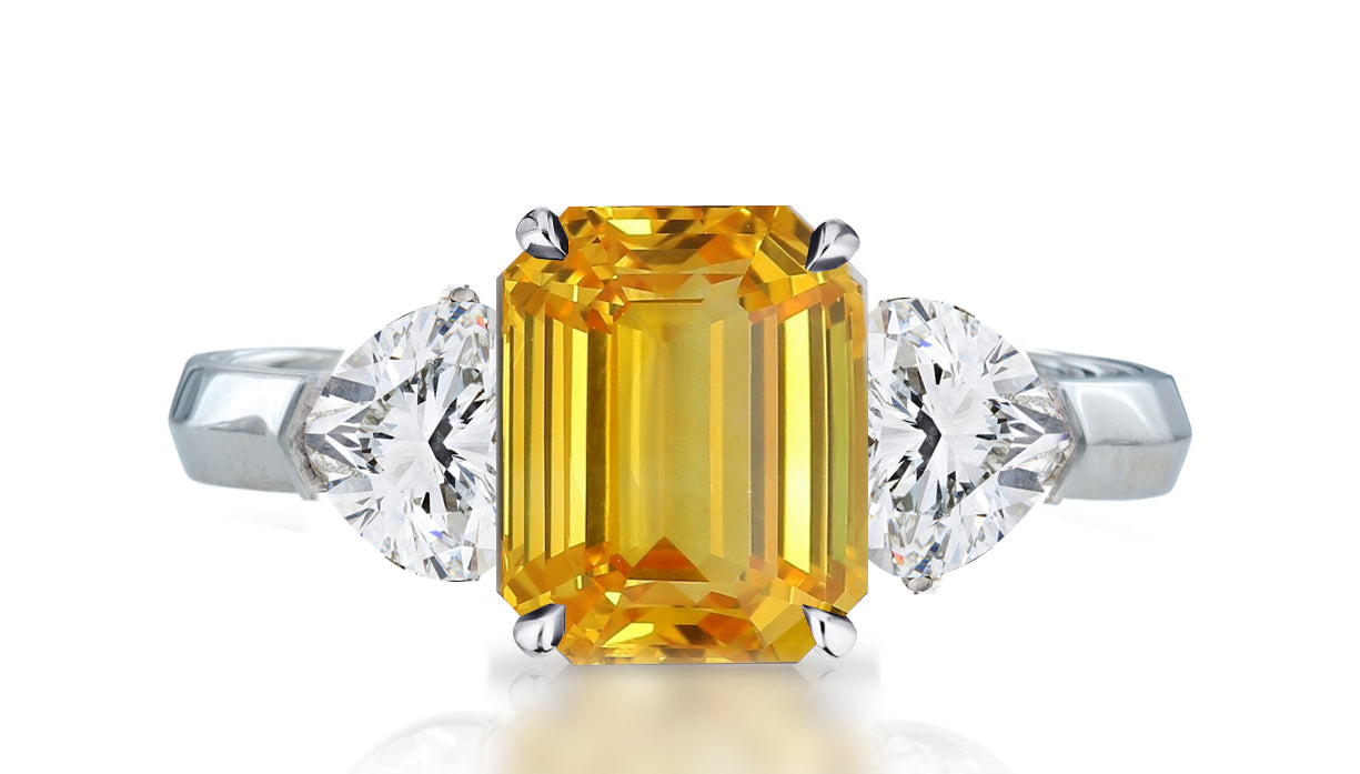 32 custom made unique emerald cut yellow sapphire center stone with heart diamond accents three stone engagement ring