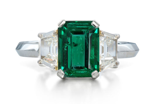 518 custom made unique emerald cut emerald center stone and trapezoid diamond accent three stone engagement ring