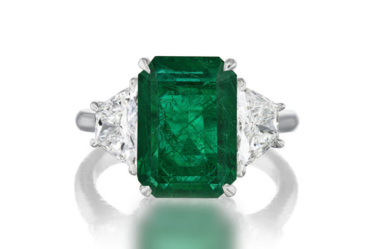 523 custom made unique emerald cut emerald center stone and trapezoid diamond accent three stone engagement ring