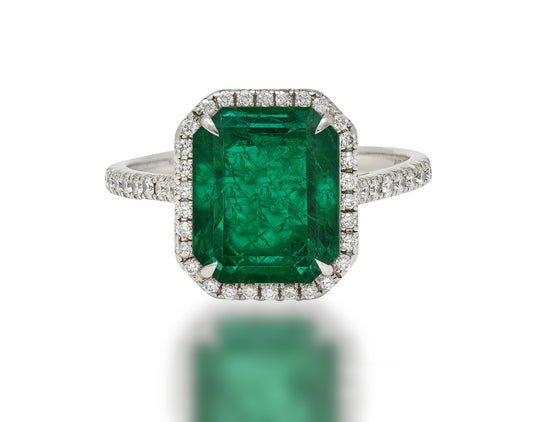 555 custom made unique emerald cut emerald center stone and round diamond halo engagement ring