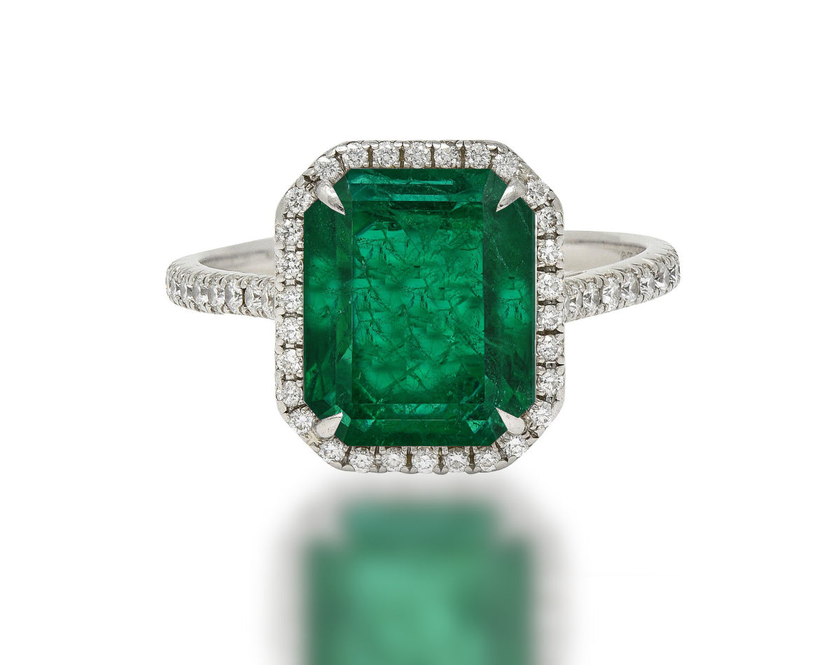 555 custom made unique emerald cut emerald center stone and round diamond halo engagement ring