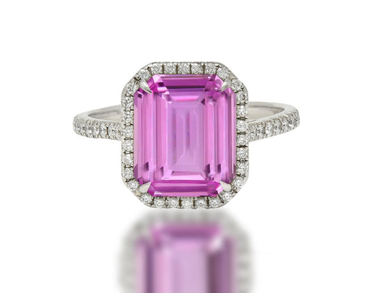 555 custom made unique emerald cut pink sapphire center stone and round diamond halo engagement ring
