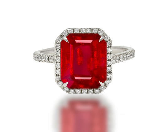 555 custom made unique emerald cut ruby center stone and round diamond halo engagement ring
