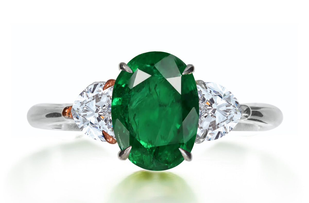615 custom made unique oval emerald center stone and heart diamond side three stone engagement ring