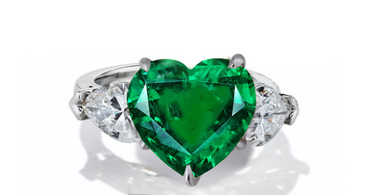 631 custom made unique heart emerald center stone and heart diamond accent three stone engagement ring