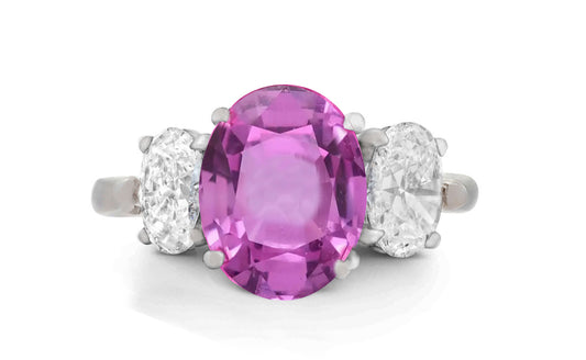 646 custom made unique oval pink sapphire center stone and oval diamond accent three stone engagement ring