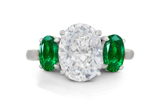 647 custom made unique oval diamond center stone and oval emerald accent three stone engagement ring