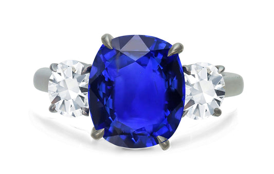 650 custom made unique oval blue sapphire center stone and round diamond accent three stone engagement ring