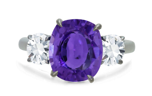 650 custom made unique oval purple sapphire center stone and round diamond accent three stone engagement ring
