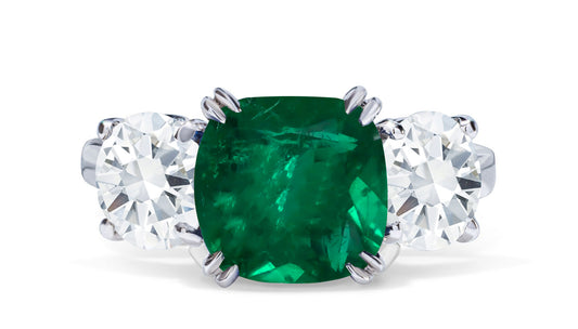 651 custom made unique cushion emerald center stone and round diamond accent three stone engagement ring