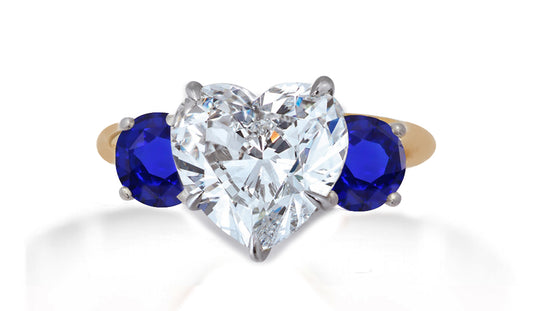 653 custom made unique heart diamond center stone and round blue sapphire accent three stone engagement ring