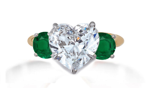 653 custom made unique heart diamond center stone and round emerald accent three stone engagement ring