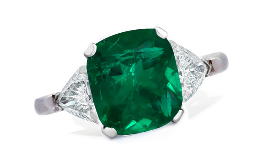 654 custom made unique cushion emerald center stone and trillion diamond accent three stone engagement ring