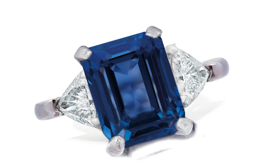 655 custom made unique emerald cut blue sapphire center stone and trillion diamond accent three stone engagement ring