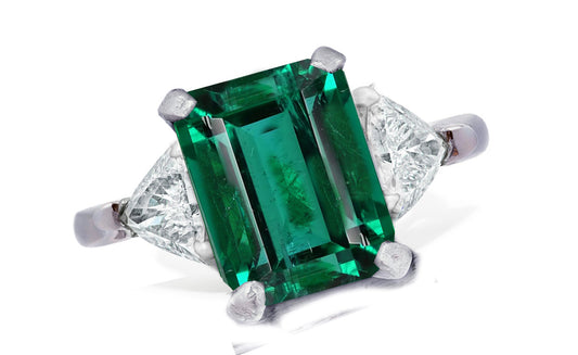 655 custom made unique emerald cut emerald center stone and trillion diamond accent three stone engagement ring