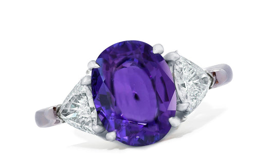 658 custom made unique oval purple sapphire center stone and trillion diamond accent three stone engagement ring