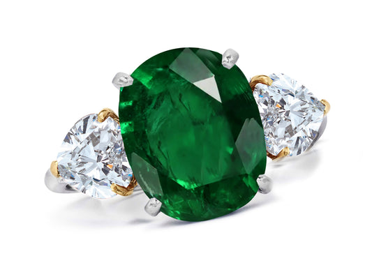 660 custom made unique oval emerald center stone and heart diamond accent three stone engagement ring