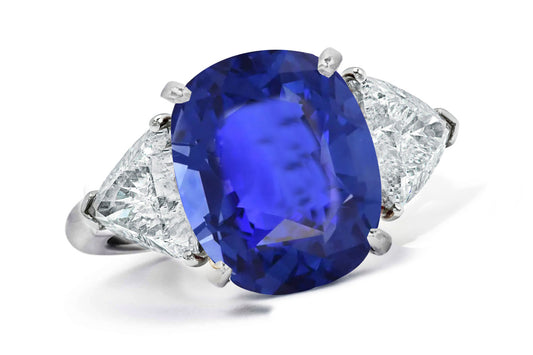 662 custom made unique oval blue sapphire center stone and trillion diamond accent three stone engagement ring