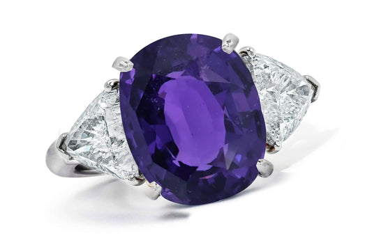 662 custom made unique oval purple sapphire center stone and trillion diamond accent three stone engagement ring