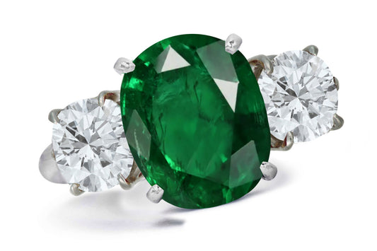 663 custom made unique oval emerald center stone and round diamond accent three stone engagement ring