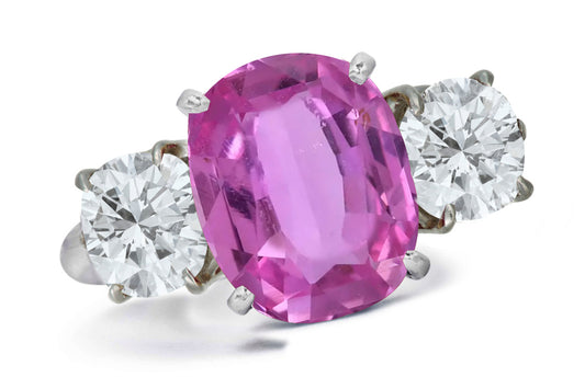 663 custom made unique oval pink sapphire center stone and round diamond accent three stone engagement ring