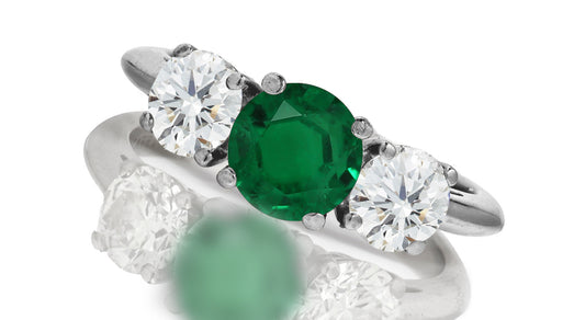 667 custom made unique round emerald center stone and round diamond accent three stone engagement ring