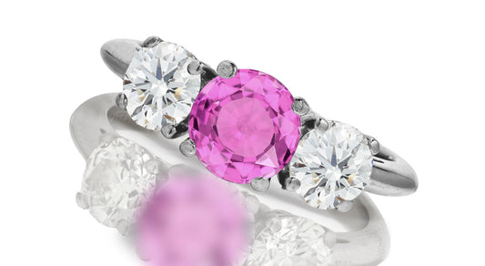 667 custom made unique round pink sapphire center stone and round diamond accent three stone engagement ring