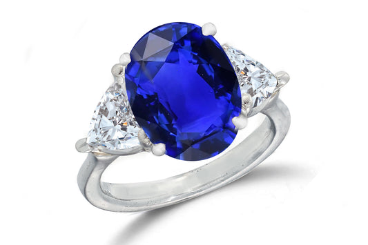 671 custom made unique oval blue sapphire center stone and heart diamond accent three stone engagement ring