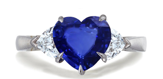 678 custom made unique heart blue sapphire center stone and heart diamond accent three stone engagement ring