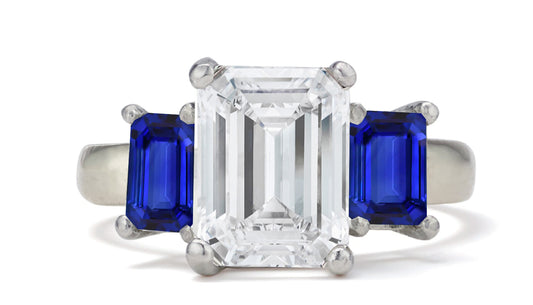 681 custom made unique emerald cut diamond center stone and emerald cut blue sapphire accent three stone engagement ring
