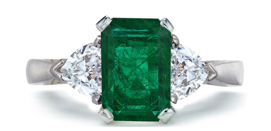 683 custom made unique emerald cut emerald center stone and heart diamond accent three stone engagement ring1