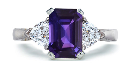 683 custom made unique emerald cut purple sapphire center stone and heart diamond accent three stone engagement ring