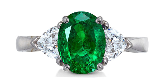 684 custom made unique oval emerald center stone and heart diamond accent three stone engagement ring