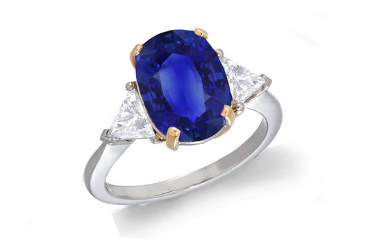 685 custom made unique oval blue sapphire center stone and trillion diamond accent three stone engagement ring