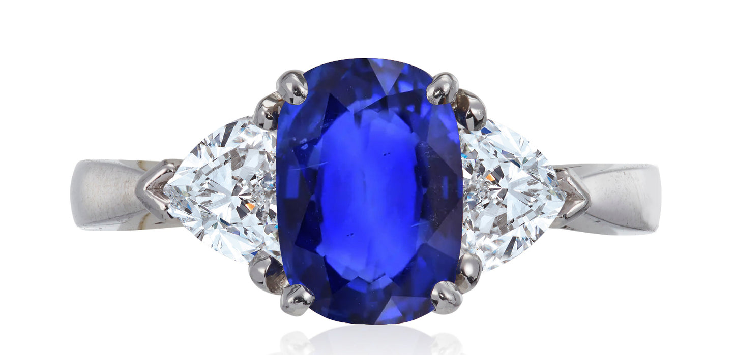 687 custom made unique oval blue sapphire center stone and heart diamond accent three stone engagement ring