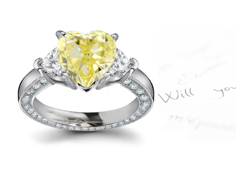 engagement ring three stone with fancy heart yellow diamond center and heart white diamond sides