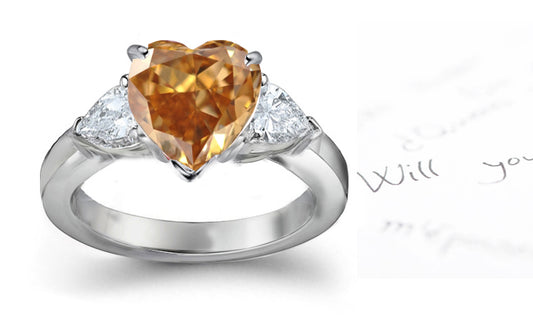 engagement ring three stone with fancy heart brown diamond center and trillion diamond sides