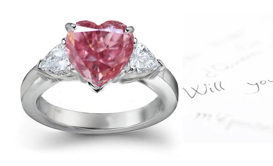 engagement ring three stone with fancy heart pink diamond center and trillion diamond sides
