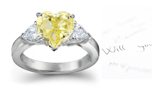 engagement ring three stone with fancy heart yellow diamond center and trillion diamond sides