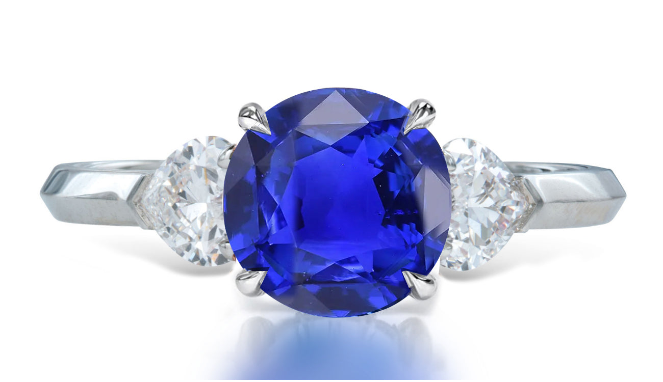 9 custom made unique round blue sapphire center stone with heart diamond accents three stone engagement ring